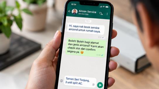 Customer booking a Zarina aircon service on WhatsApp from their phone